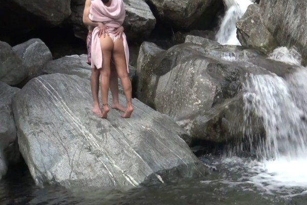 Amateur sex on a rock near a gorgeous waterfall