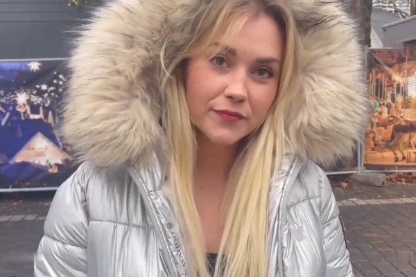 A German prostitute is fucked behind a car in a down jacket